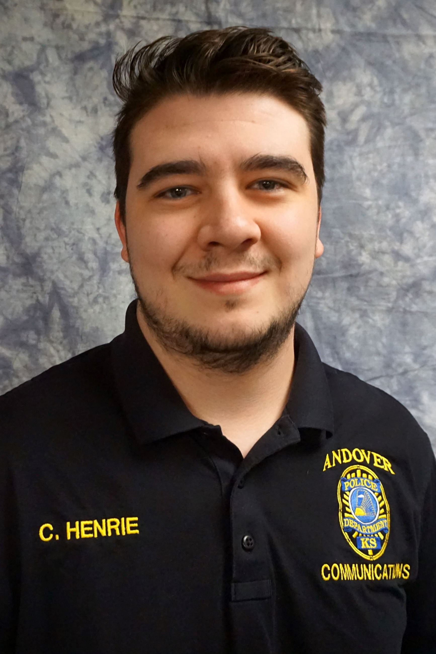 brunette male in navy polo shirt