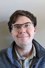 headshot of a male with glasses