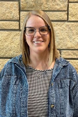 Female with blond hair and glasses