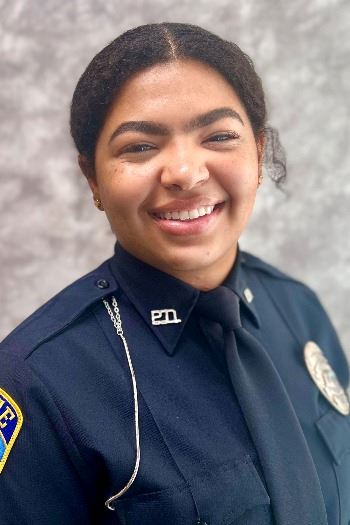 Headshot of dark haired female police officer in uniform