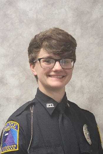Headshot of female with short hair wearing glasses and a police uniform