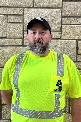 Headshot of male with facial hair wearing a hat