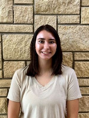 headshot of female with dark shoulder length hair