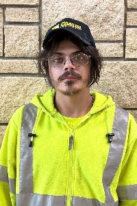 headshot of a male with dark hair and glasses wearing a ball cap