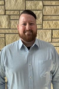 headshot of male with mustache and beard